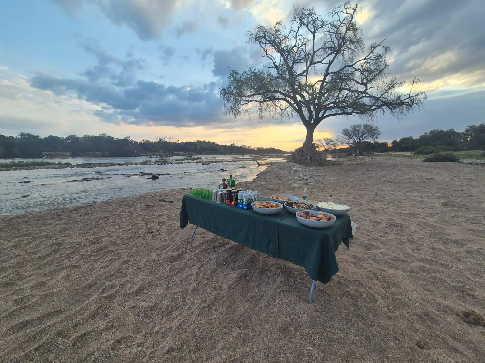 Kosher table setup near a river and safari landscape